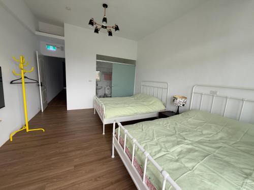 a bedroom with two beds and a mirror at Living in the mountains in San-wan