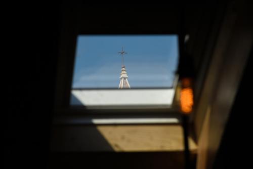 a view of a window with a tower in the distance at Pylon Rooms in Split