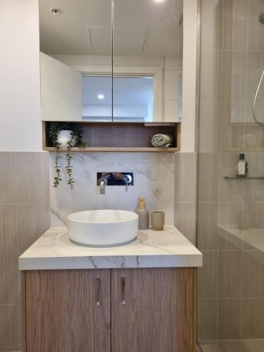 a bathroom with a sink and a shower at Southbank Bay Views Free parking WIFI smart TV in Melbourne