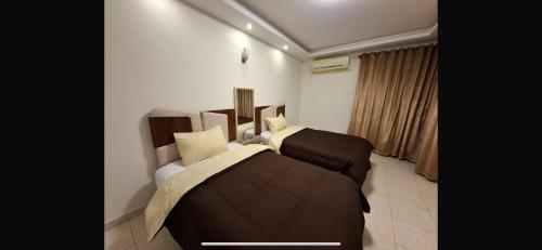 a bedroom with two beds in a room at Deluxe Direct Nile Apartment in Cairo