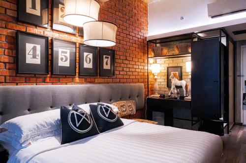 a bedroom with a bed and a wall with numbers on it at M Boutique Hotel in Ipoh