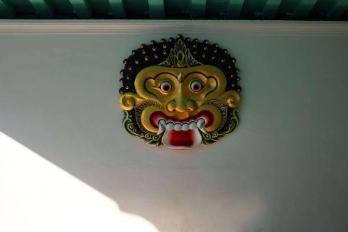 a mask hanging on a wall on a wall at Garrya Bianti Yogyakarta in Yogyakarta