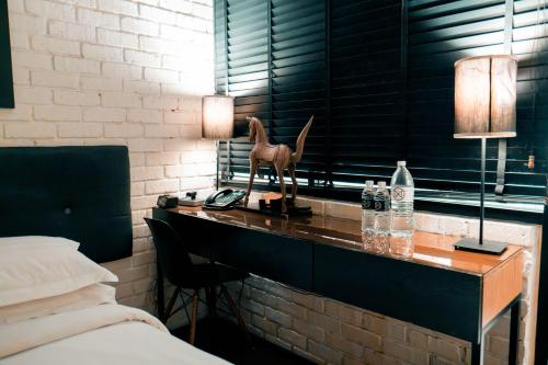 a bedroom with a desk with a horse statue on it at M Boutique Hotel in Ipoh