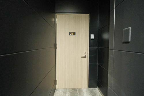 a door with a sign on it in a bathroom at HOTEL ALL IN Kumamoto in Kumamoto
