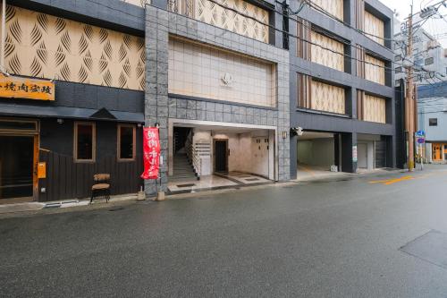 an empty street in front of a building at HOTEL ALL IN Kumamoto in Kumamoto