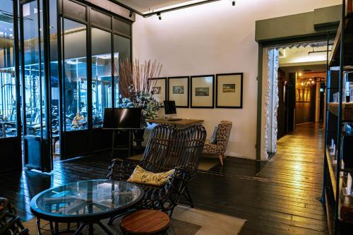 a room with a glass table and chairs and a table at M Boutique Hotel in Ipoh