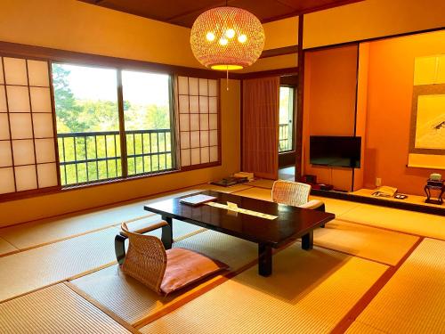 a living room with a table and chairs at Musashino Bekkan in Hakone