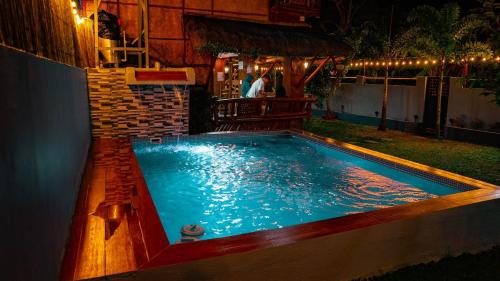 a swimming pool in a backyard at night at TANGLAW - A Private Rest house with pool near Tagaytay City in Alfonso