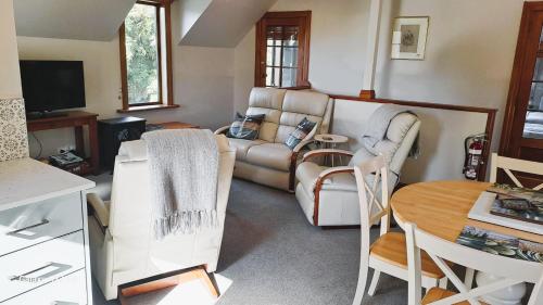 a living room with a couch and a table at Awatuna Homestead in Awatuna