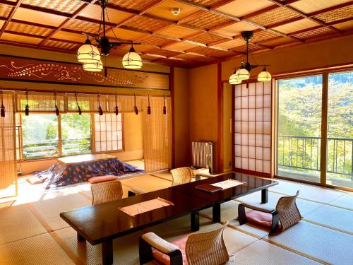 a living room with a table and chairs at Musashino Bekkan in Hakone