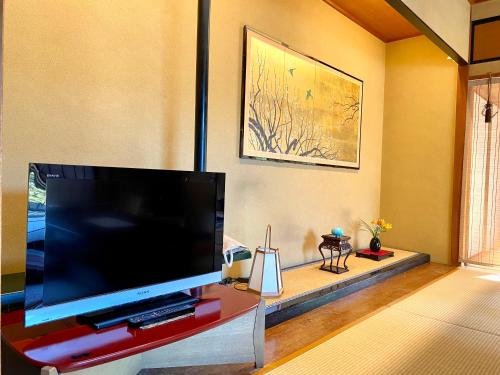 a living room with a large flat screen tv at Musashino Bekkan in Hakone