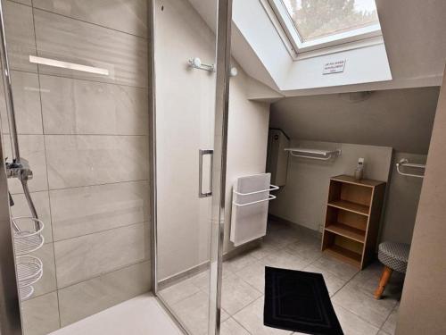 a bathroom with a shower and a skylight at Gîte Tourangelle avec Piscine Intérieure, Wifi, Jardin - FR-1-381-619 in Assay