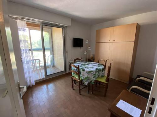 une salle à manger avec une table et des chaises et un balcon dans l'établissement Studio 4 pers. au Port avec Parking - Canet-Plage - FR-1-750-71, à Canet