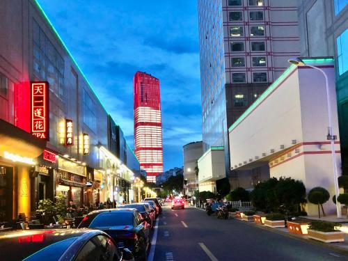 a street with cars parked on the side of a city at Ningbo Portman Plaza Hotel in Ningbo