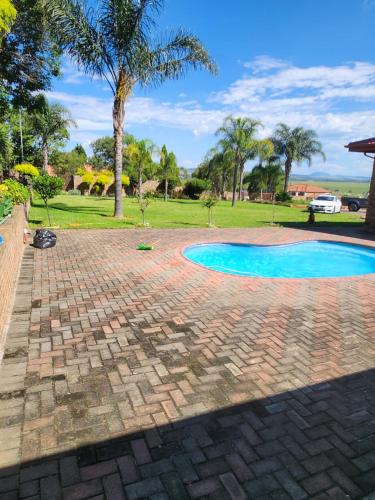 a brick walkway around a swimming pool in a park at The Hills at 1 Meeu in Newcastle