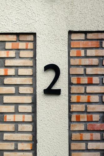 a number on the side of a brick wall at Casa Mar Atins in Atins