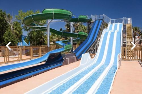 a water slide at a water park at Mobil home haut de gamme 6 personnes camping 4 étoiles Marvilla Parks BARCARES plage in Torreilles