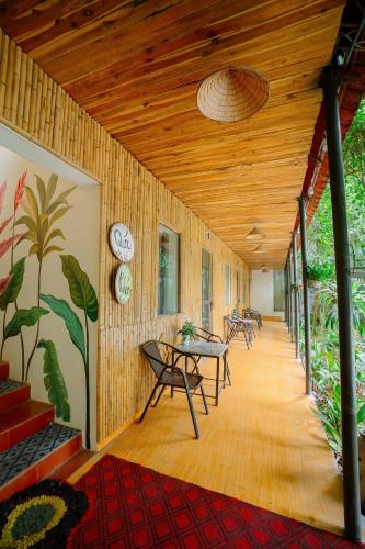 a hallway with tables and chairs and a wooden ceiling at Ali Garden Homestay Trang An Ninh Bình in Xuân Sơn