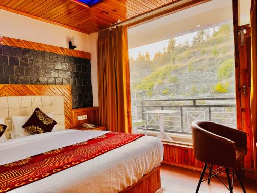 a bedroom with a bed and a large window at Nature Valley View Resort KOTI - on Chail Road with Parking in Kūfrī