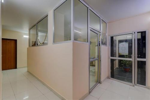 an empty room with glass walls and windows at FabHotel Raas Inn in Lucknow