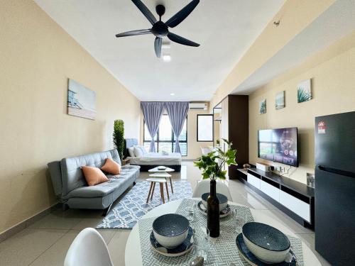 a living room with a couch and a ceiling fan at Alinea Suites by Moka in Shah Alam