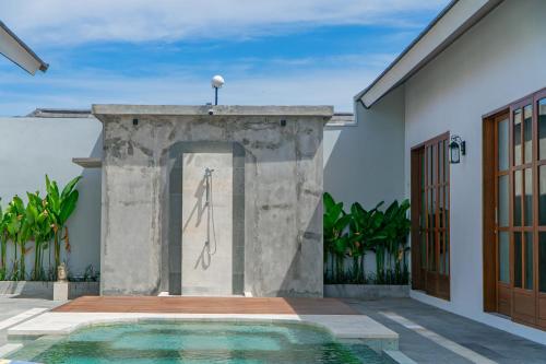 an entrance to a house with a swimming pool at Kardi Residence By Bali Cabin in Cemagi