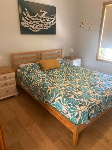 a bedroom with a bed with a comforter at Bayhaven- Best deal 4 bedroom 2 bathroom getaway in Port Moonta