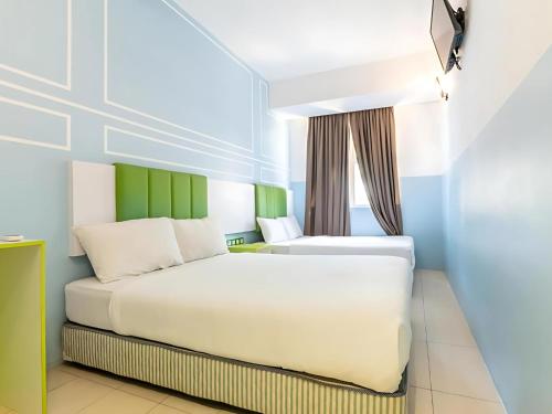 Postel nebo postele na pokoji v ubytování Seeds Hotel Bukit Bintang