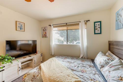 a bedroom with a bed and a flat screen tv at 7 Mi to Soboba Casino Hemet Home with Patios! in Hemet
