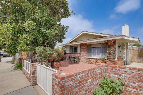 a brick house with a brick wall and a fence at 7 Mi to Soboba Casino Hemet Home with Patios! in Hemet