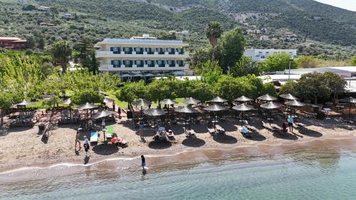 an aerial view of a beach with chairs and umbrellas at Apollon Hotel in Ancient Epidavros