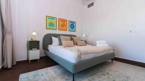 a bedroom with a bed with pillows on it at Two Bed In Ansam Hosted By Voyage in Abu Dhabi