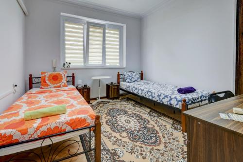 a small room with two beds and a window at Steady - Guests Rooms in Varna City