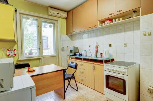 a kitchen with a table and a chair in it at Steady - Guests Rooms in Varna City