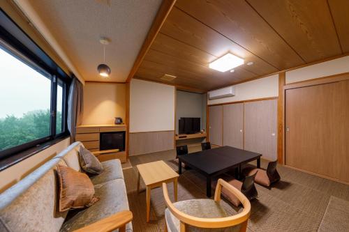 a living room with a table and a couch at Jizaiso in Nasu