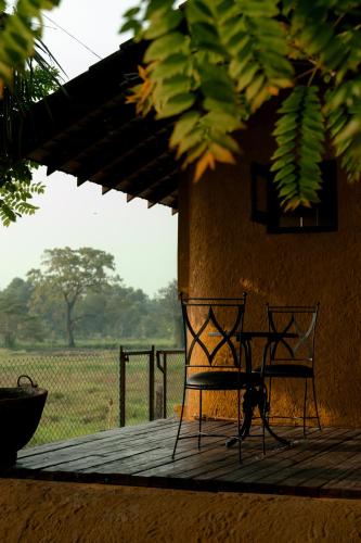 a table and chairs sitting on a wooden deck at Kirindi Paddy Isle in Negombo