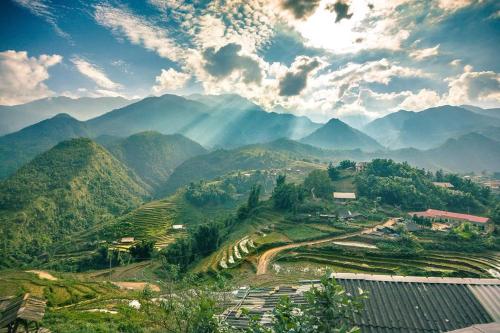 a view of a mountain valley with mountains at Hà Giang Hotel Sapa in Sa Pa