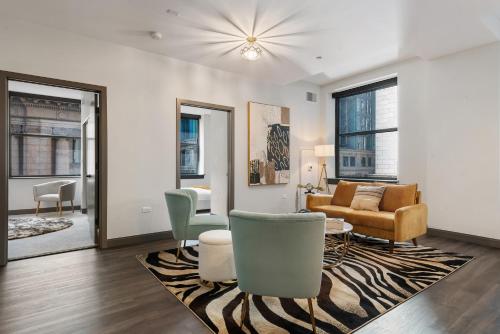 a living room with a couch and a table at Experience Downtown Chicago at Millennium - Luxury Apartments in The Loop in Chicago