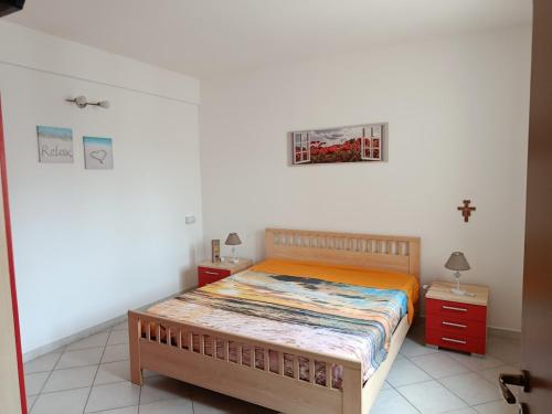 a bedroom with a bed and a cross on the wall at Relax beach San Vito lo Capo in San Vito lo Capo