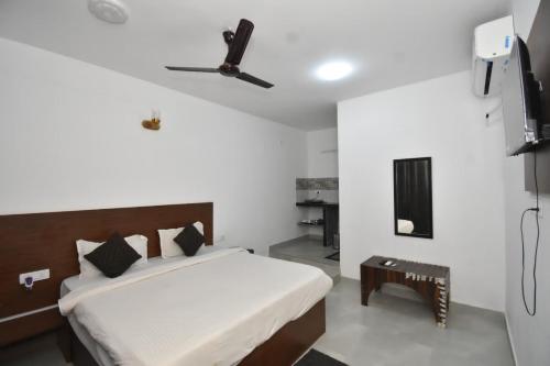 a bedroom with a bed and a ceiling fan at Hotel de gracia baga beach in Baga