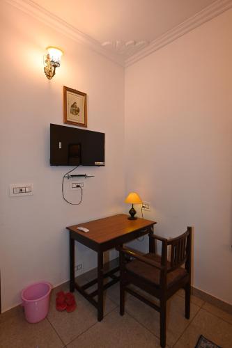 a desk with a lamp and a chair in a room at Ardas Villa Bikaner - Heritage Luxury Boutique Stay in Bikaner