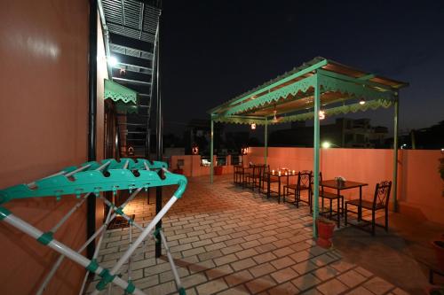a group of tables and chairs on a patio at night at Ardas Villa Bikaner - Heritage Luxury Boutique Stay in Bikaner