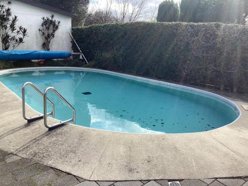 a small swimming pool in a yard with a fence at Tranquille in Tauranga in Tauranga