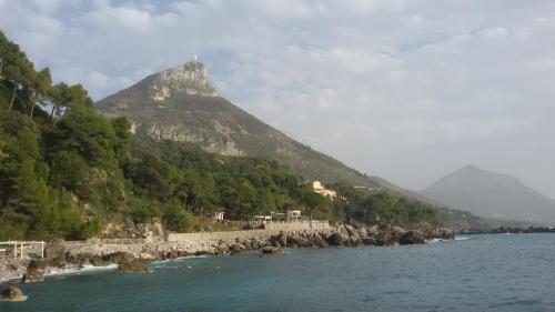 a mountain sitting next to a body of water at B&B HF Fiorella in Maratea