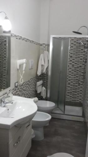 a bathroom with a shower and a toilet and a sink at B&B HF Fiorella in Maratea