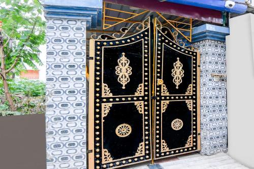 a black and gold door on a building at Super Hotel O Kolkata Near Acropolis Mall Formerly 7 Horse GH in Kolkata