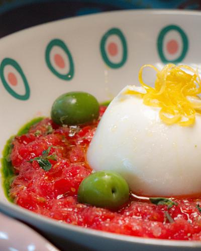 a bowl of food with green olives and sour cream at AS Boutique Hotel, superior in Ljubljana