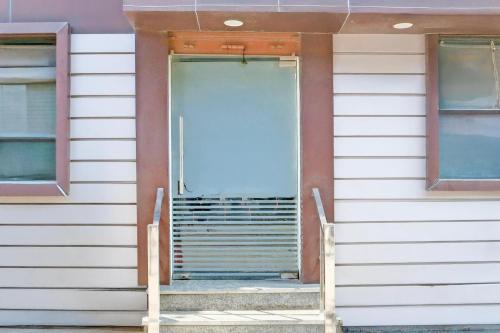 an open door on a house with two windows at Super Hotel O Chandigarh Highway Near Prabhat Road in Zirakpur