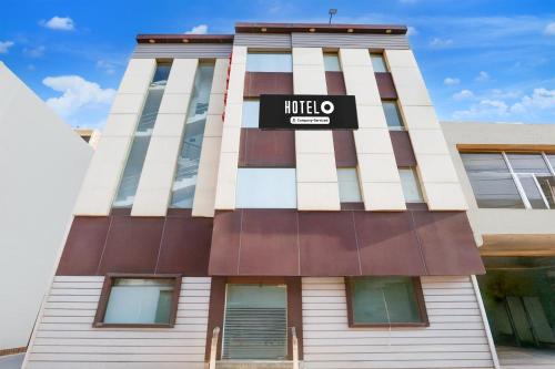 a building with a hotel sign on it at Super Hotel O Chandigarh Highway Near Prabhat Road in Zirakpur