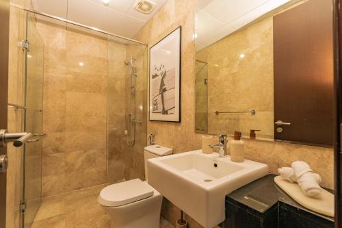 a bathroom with a sink and a toilet and a shower at Voyage Two Bedroom In Reem Island in Abu Dhabi